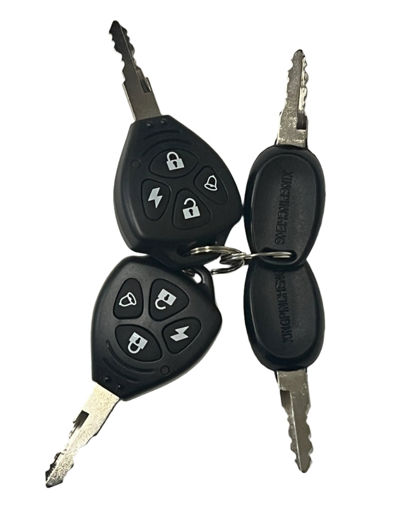 Two car keys with keychains on a light gray surface