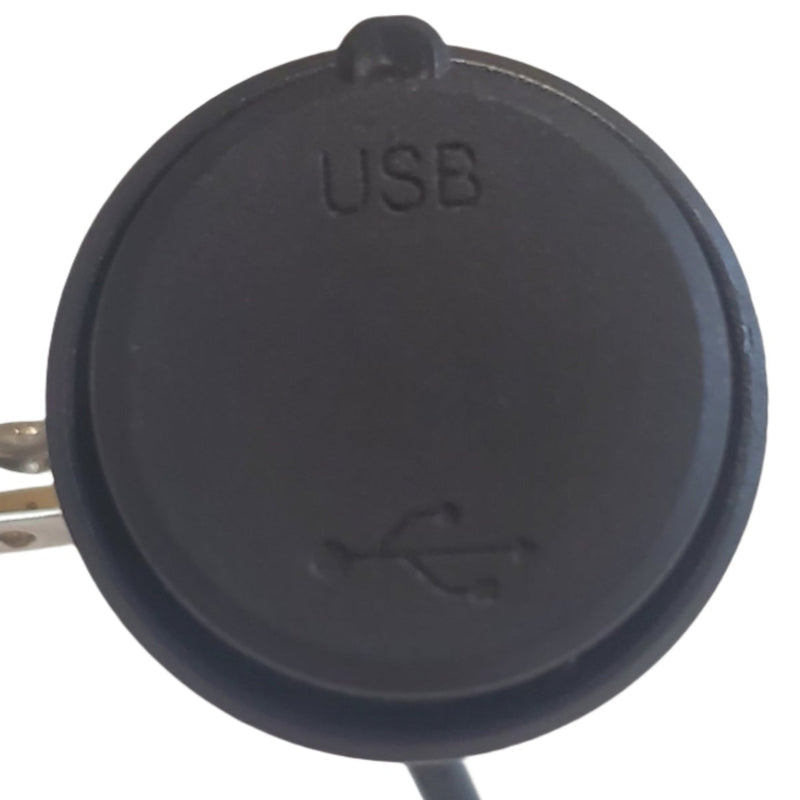 Black USB port cover on a white electronic device with blurred background