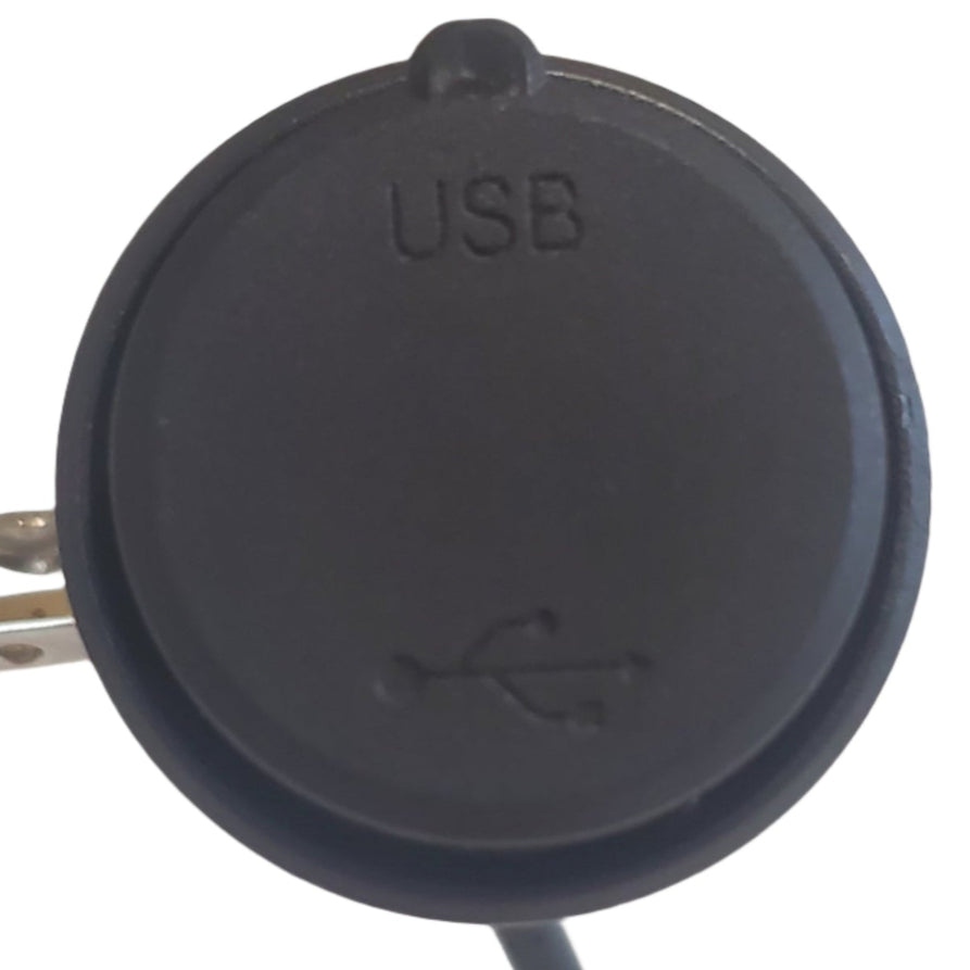 Black USB port cover on a white electronic device with blurred background